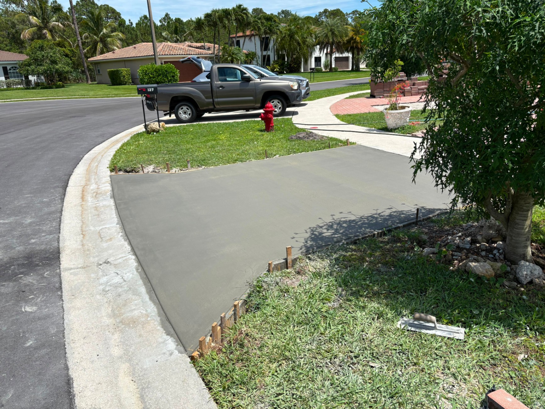 Fresh concrete driveway apron pour at curb