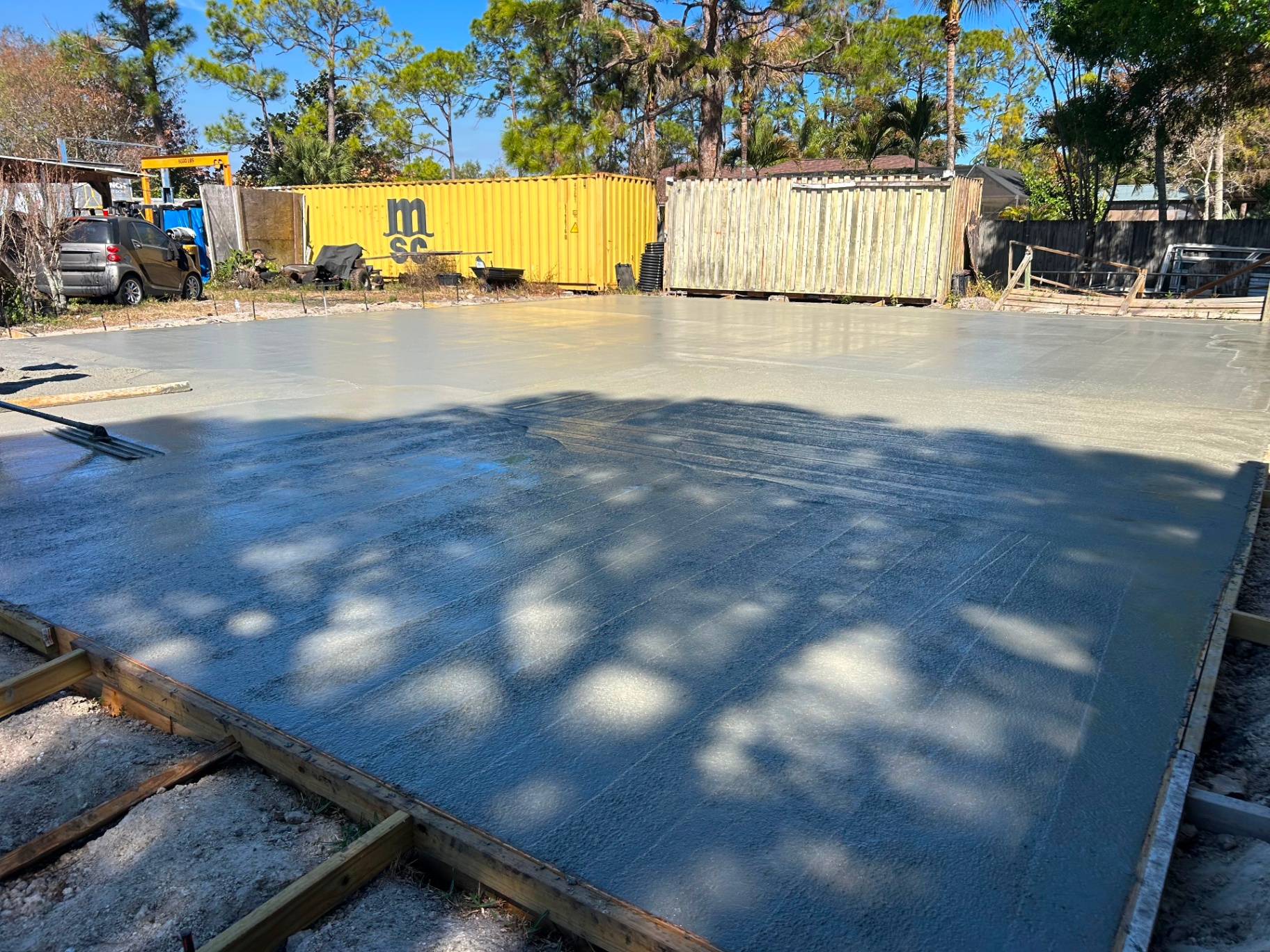 Freshly poured large concrete slab being finished