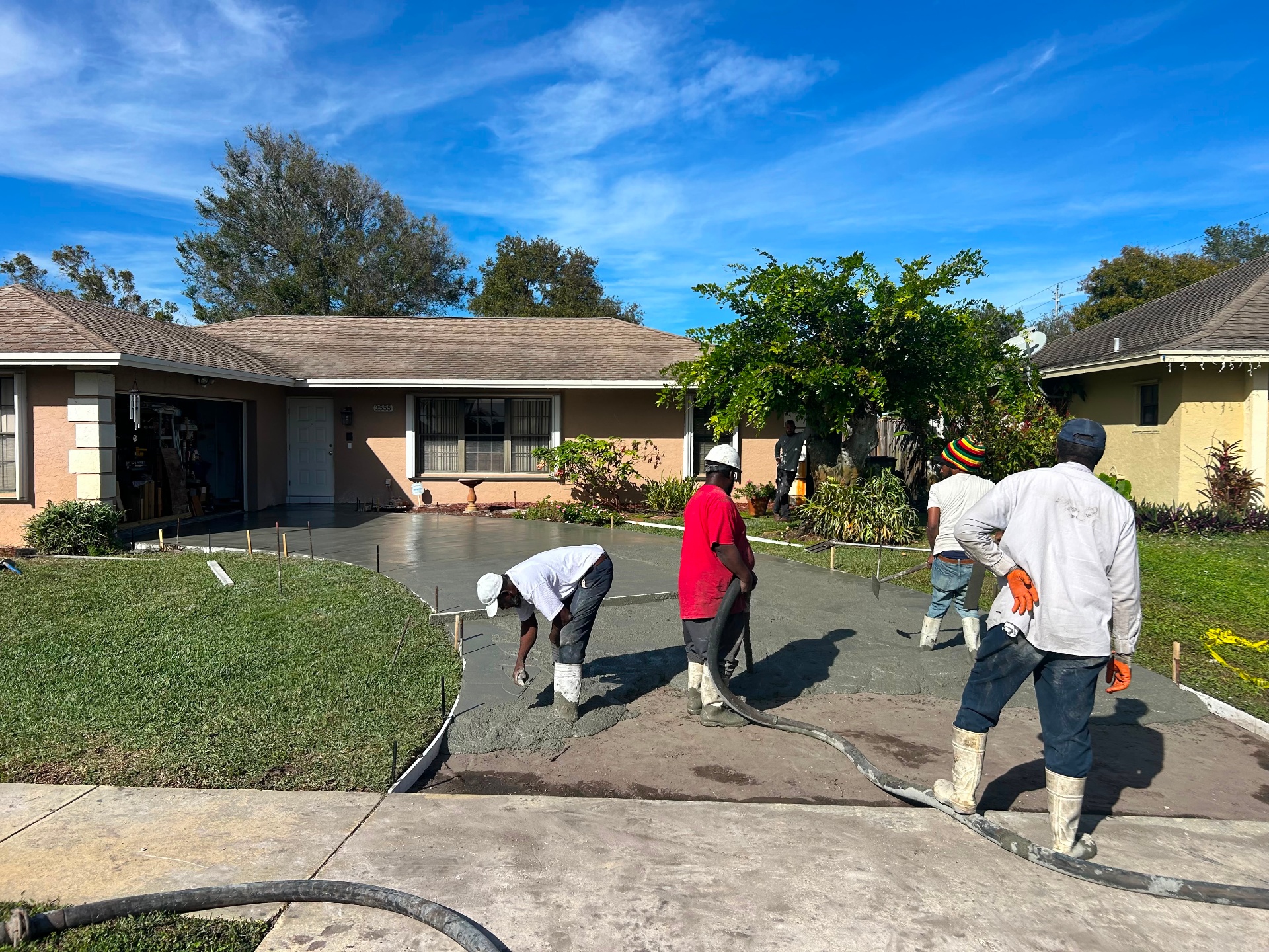 Premier crew pouring and finishing a new concrete driveway