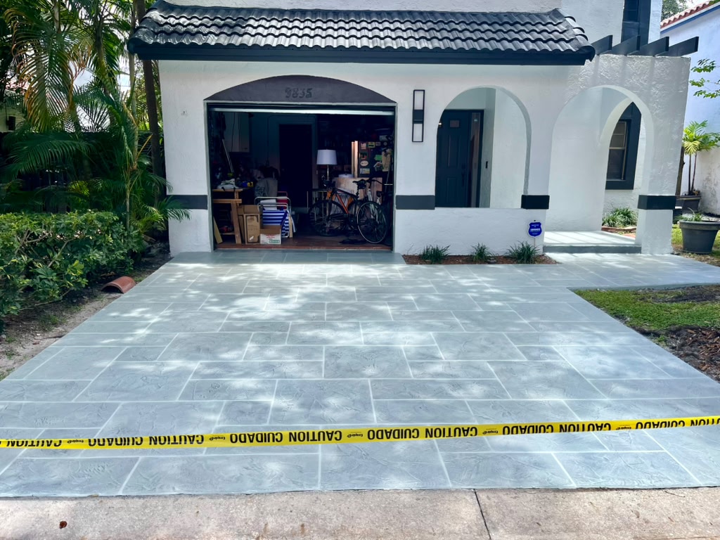 Ashlar slate stamped concrete driveway leading to garage