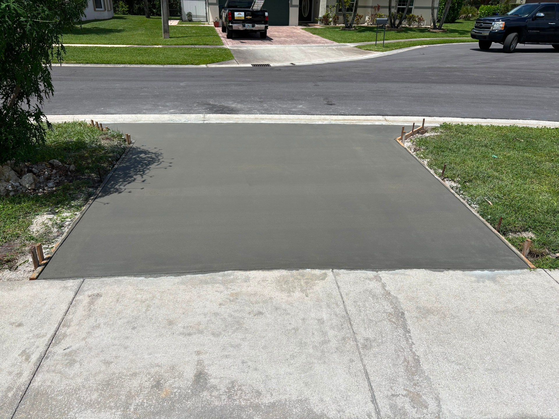 Freshly poured smooth concrete driveway apron