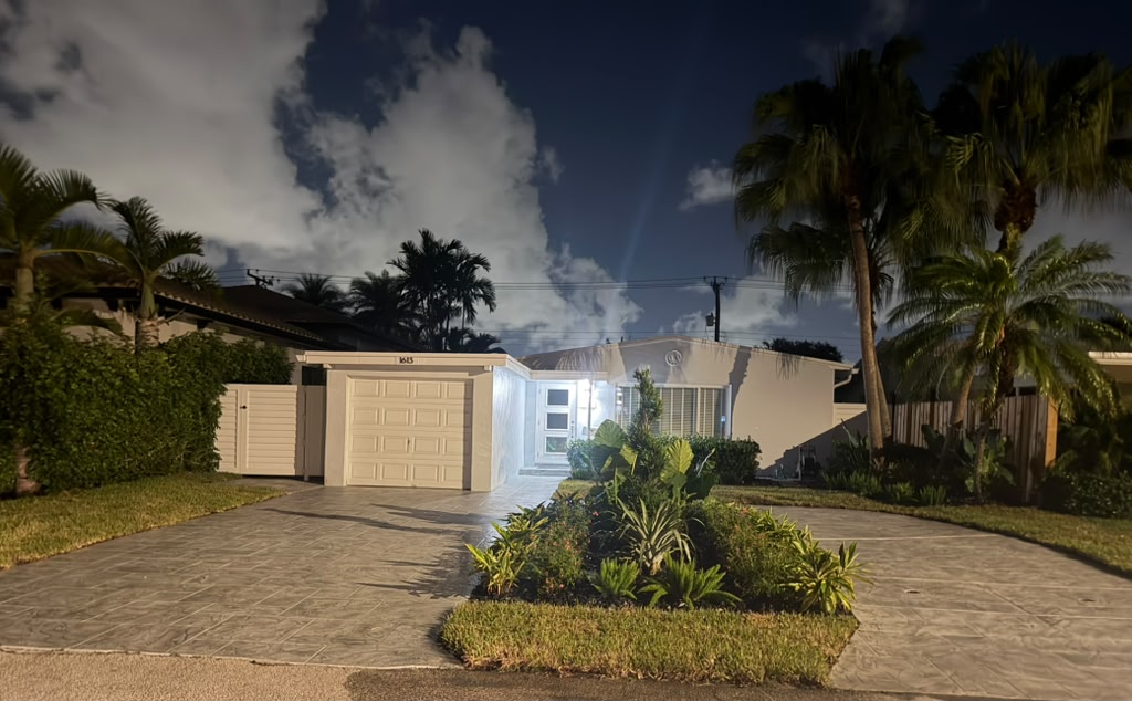 Stamped concrete driveway illuminated at night