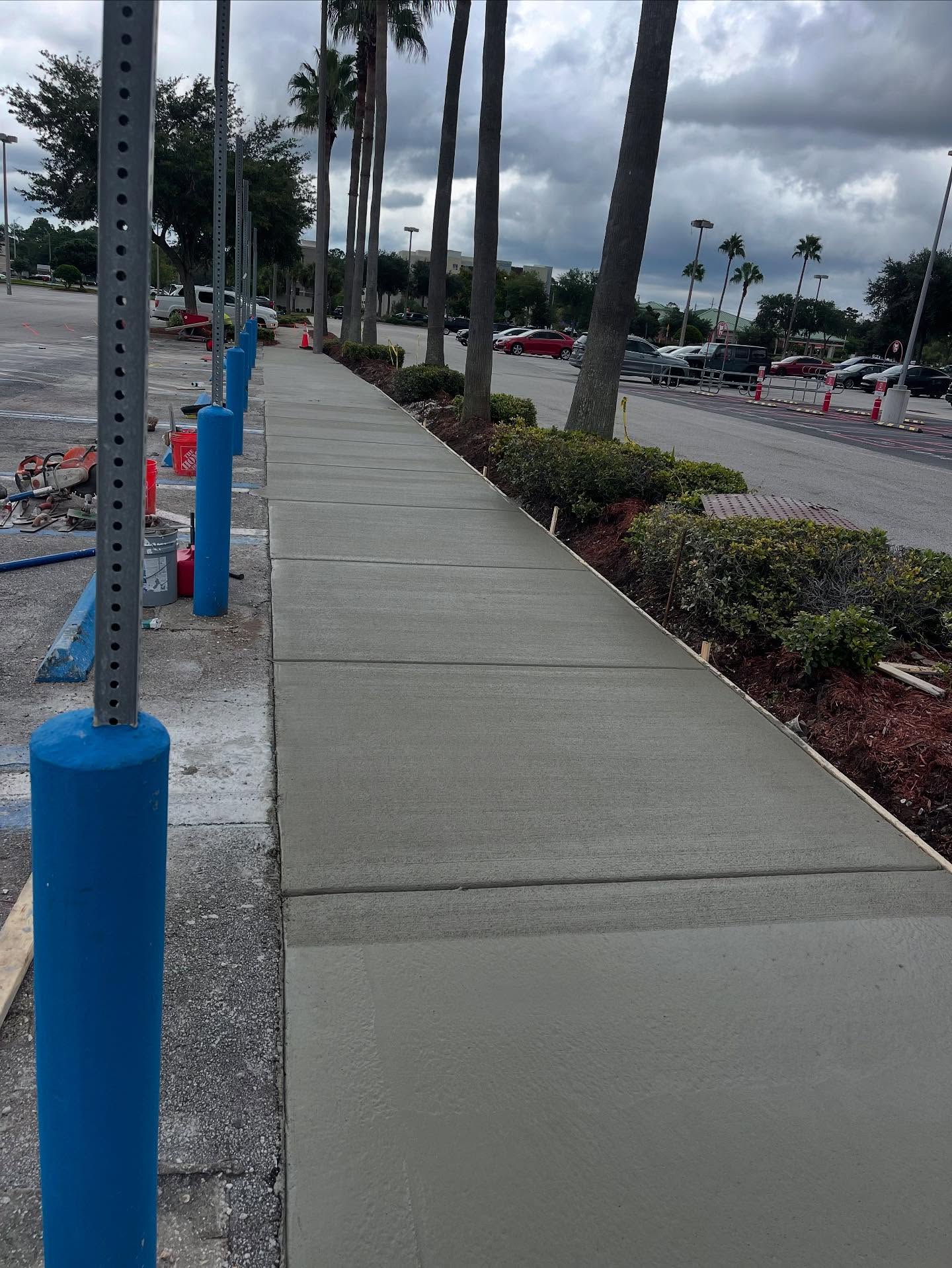 Commercial concrete sidewalk along parking lot