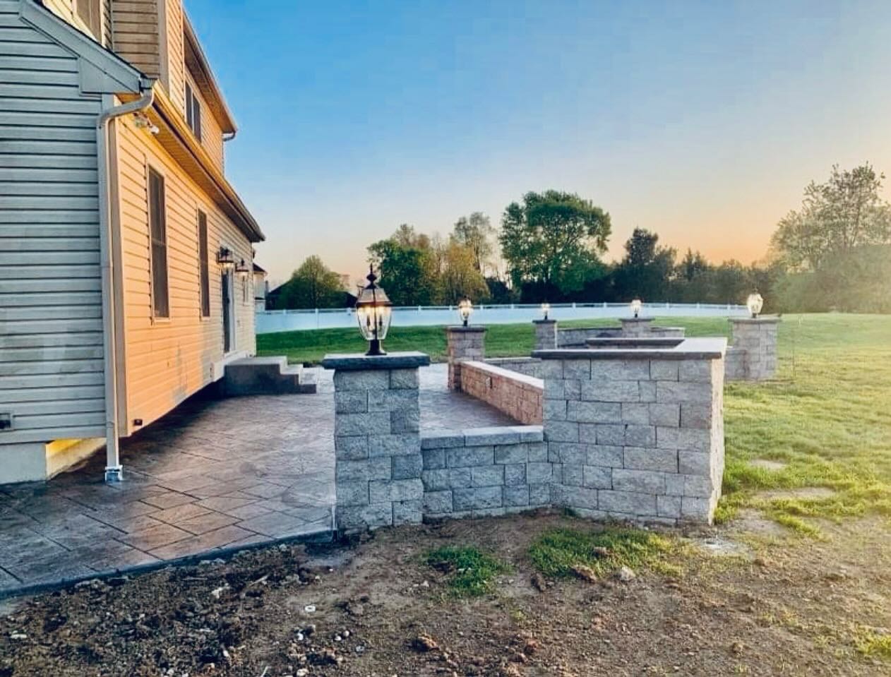 Stamped patio with block seating wall and lighted columns