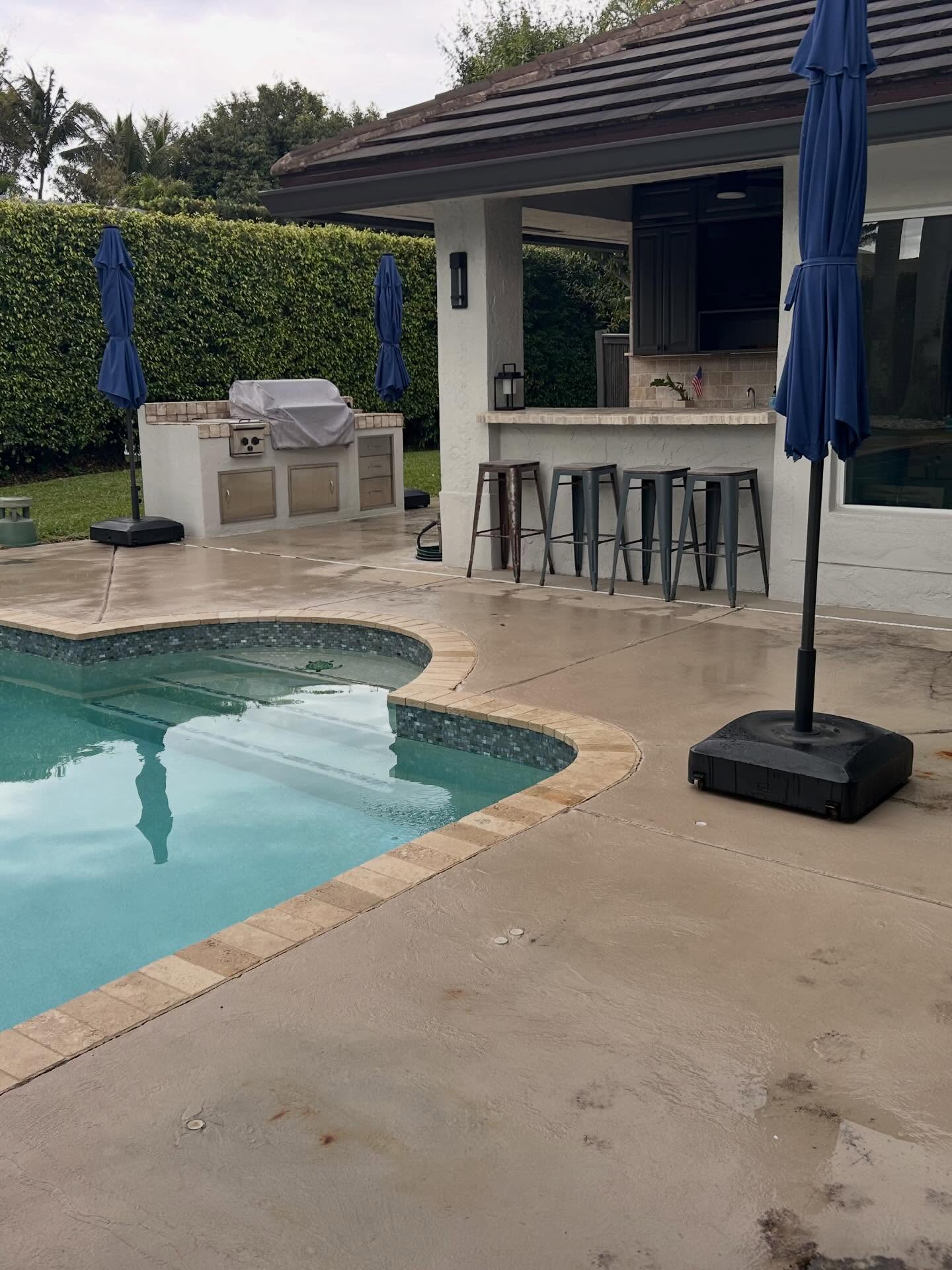 Pool deck with outdoor kitchen and bar area