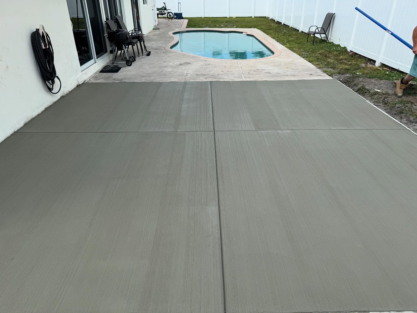 Newly poured concrete pool deck extension